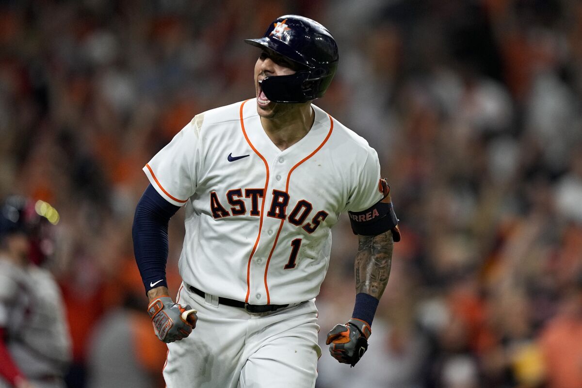 Houston Astros' Carlos Correa celebrates a home run against the Boston Red Sox during the seventh inning in Game 1 of baseball's American League Championship Series Friday, Oct. 15, 2021, in Houston. (AP Photo/David J. Phillip)
