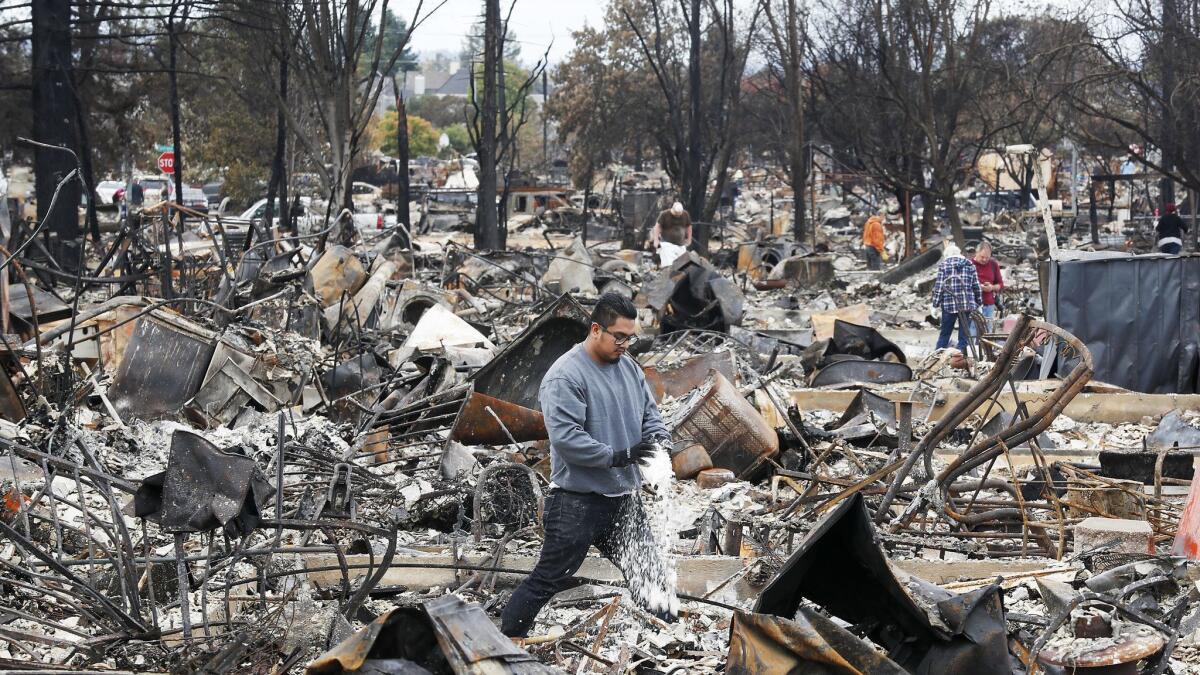 Jesus Climaco and other residents of the Coffey Park neighborhood in Santa Rosa sift through the remains of their burned homes on Oct. 20, 2017.
