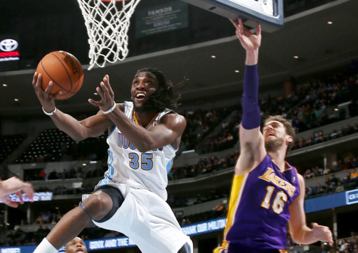 Nuggets forward Kenneth Faried gets past Lakers power forward Pau Gasol for a reverse layup in the fourth quarter.