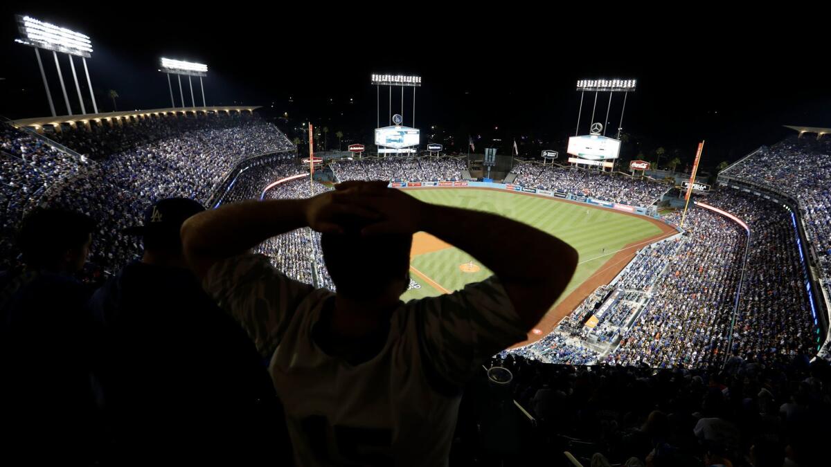 A frustrated Dodgers fan watches Game 7 of the World Series.