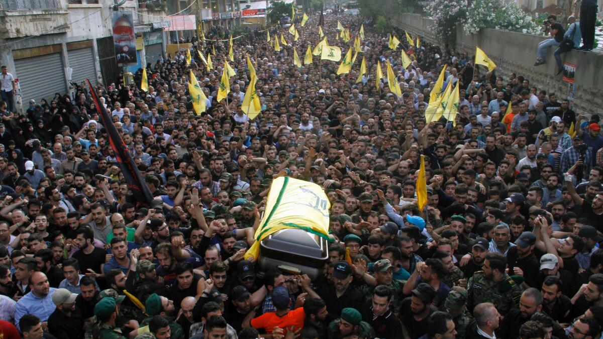 The coffin of Hezbollah military commander Mustafa Amin Badreddine is carried through the streets of southern Beirut during his funeral on May 13, 2016.
