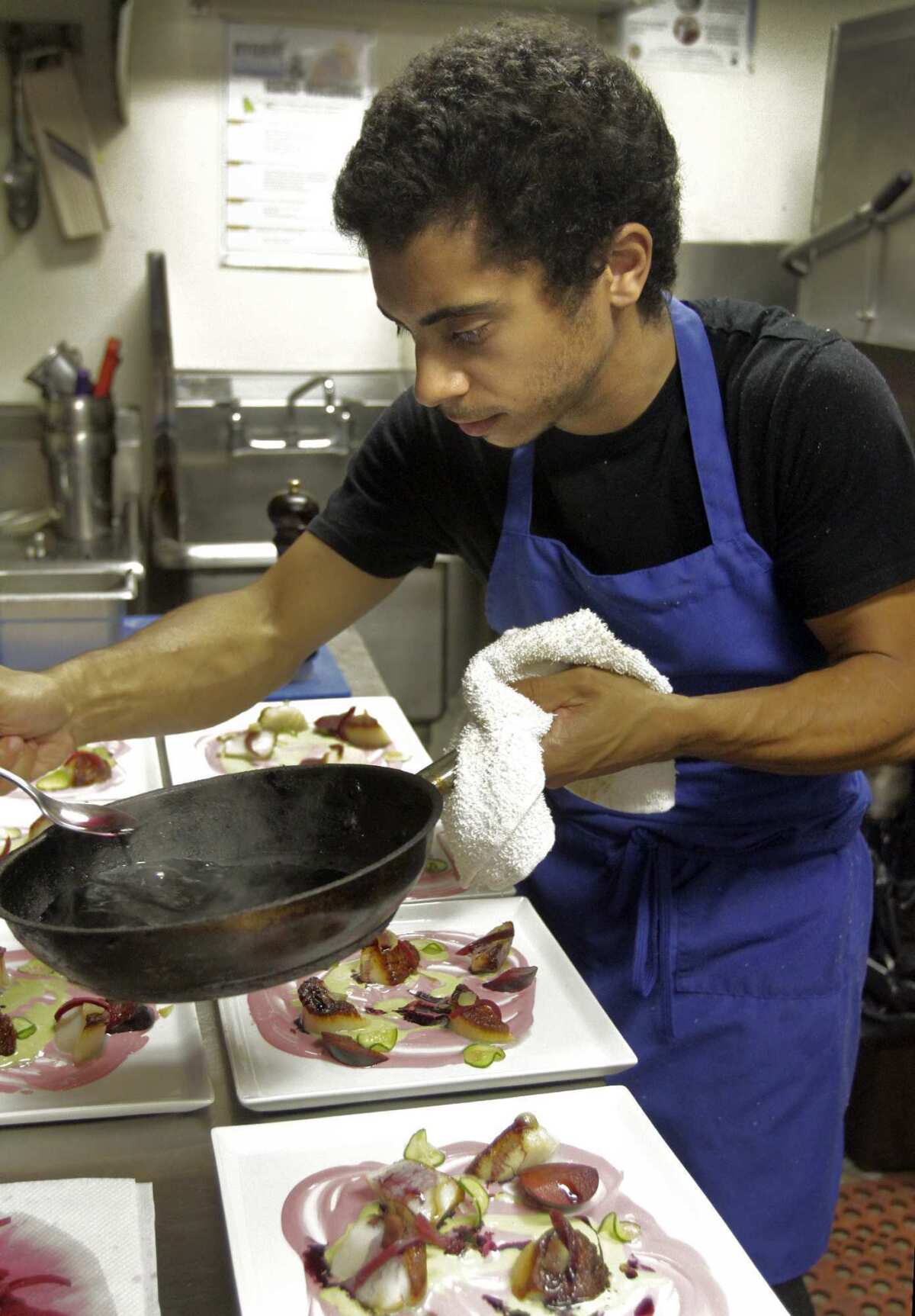 Chef Miles Thompson in the kitchen preparing food at the restaurant at Allston Yacht Club in Echo Park. The location is where the chef's pop-up restaurant Vagrancy Project has taken up residence.