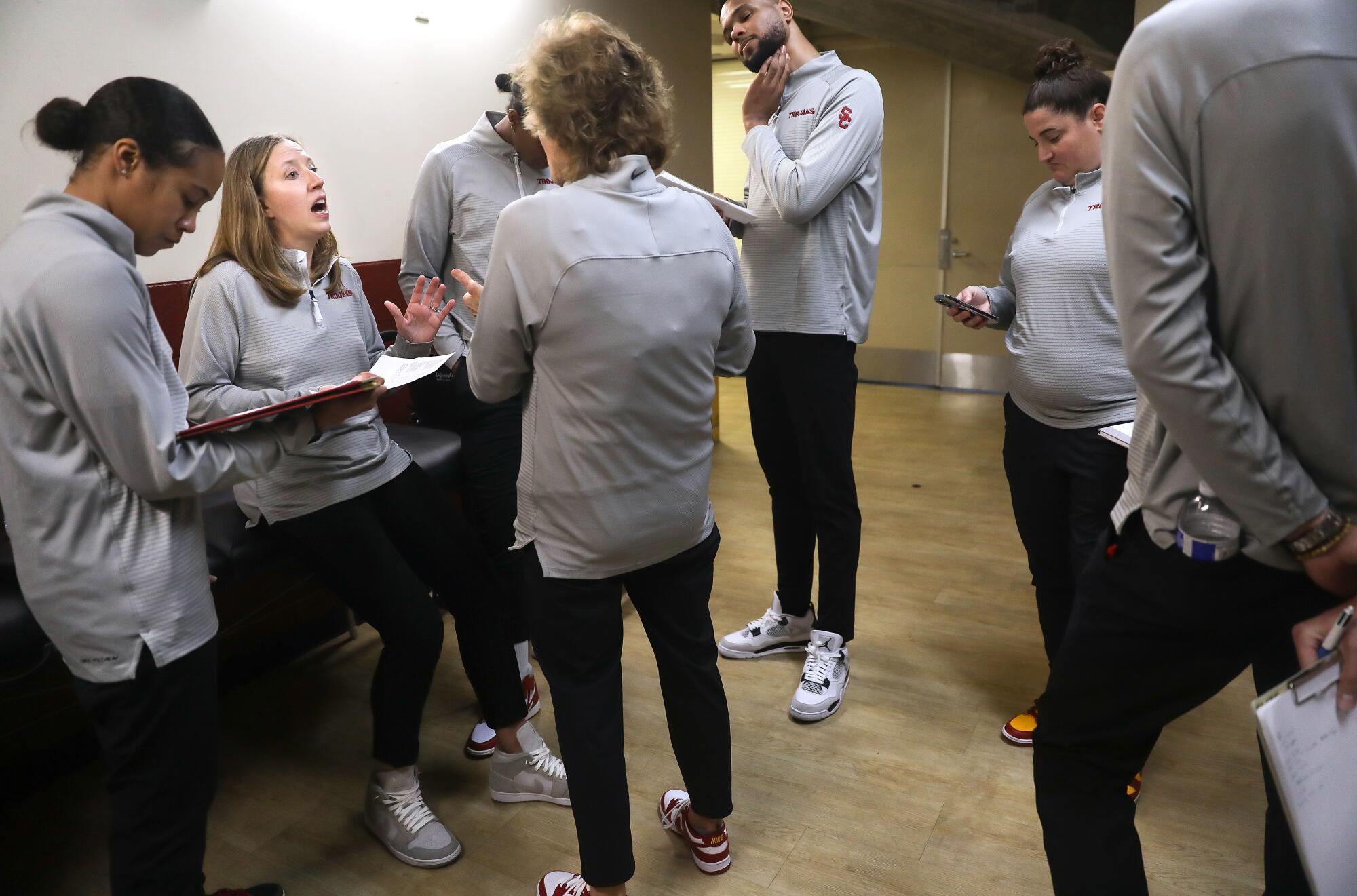 USC women's basketball head coach Lindsay Gottlieb meets with her staff at halftime.