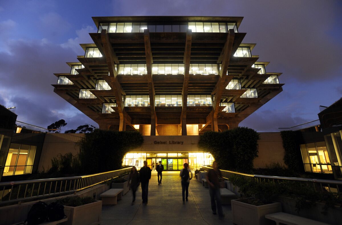 People walked to and from UC San Diego's Geisel Library, which was lit on a November night in 2010.