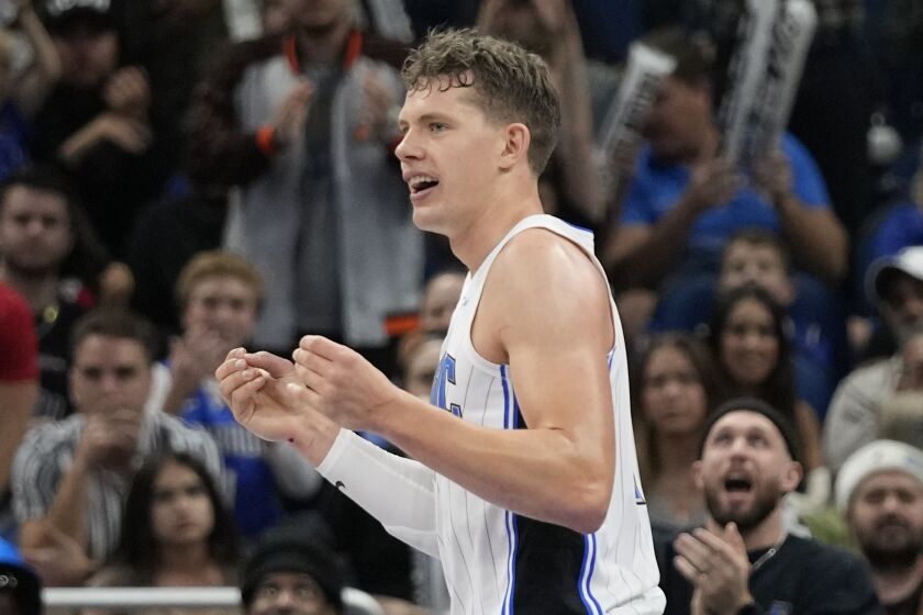 Orlando Magic's Moritz Wagner reacts after drawing a charging foul from Toronto Raptors' Gary Trent Jr. during the second half of an NBA basketball game Friday, Dec. 9, 2022, in Orlando, Fla. (AP Photo/John Raoux)