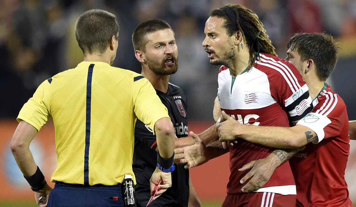 New England Revolution midfielder Jermaine Jones, second from right, is restrained by teammate Kelyn Rowe , right, and D.C. United midfielder Perry Kitchen, second from left, after he was given a red card and ejected during the second half of an MLS playoff soccer game on Oct. 28.