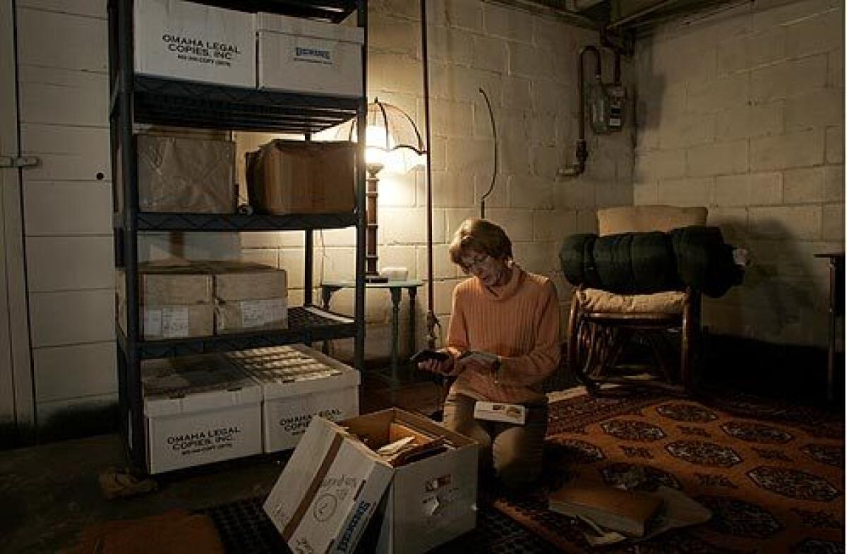 In the basement of her Omaha home, Pam Griffin looks through a box of photos stored with many boxes full of documents that she has accumulated over decades of her husband's imprisonment.