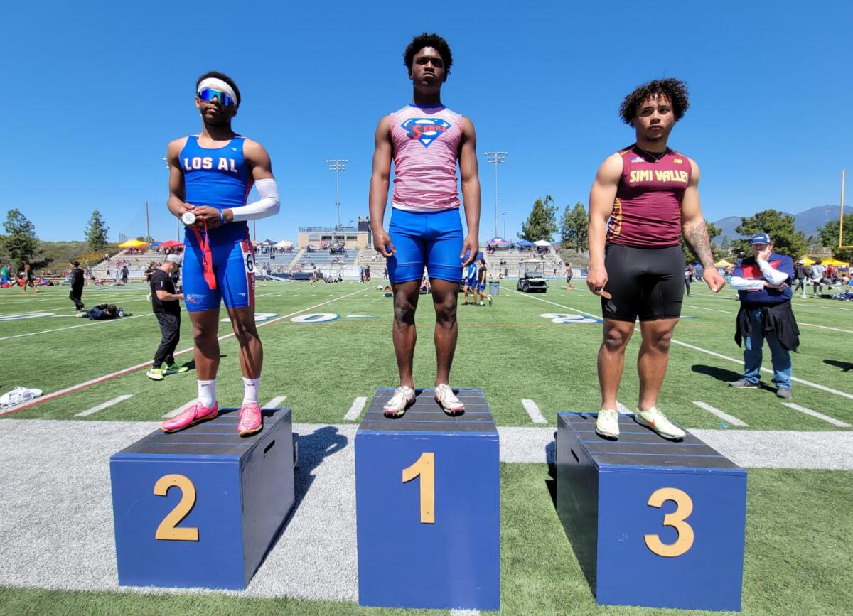 Sprinters take the podium after placing in the 100 meters at the Trabuco Hills Invitational. 