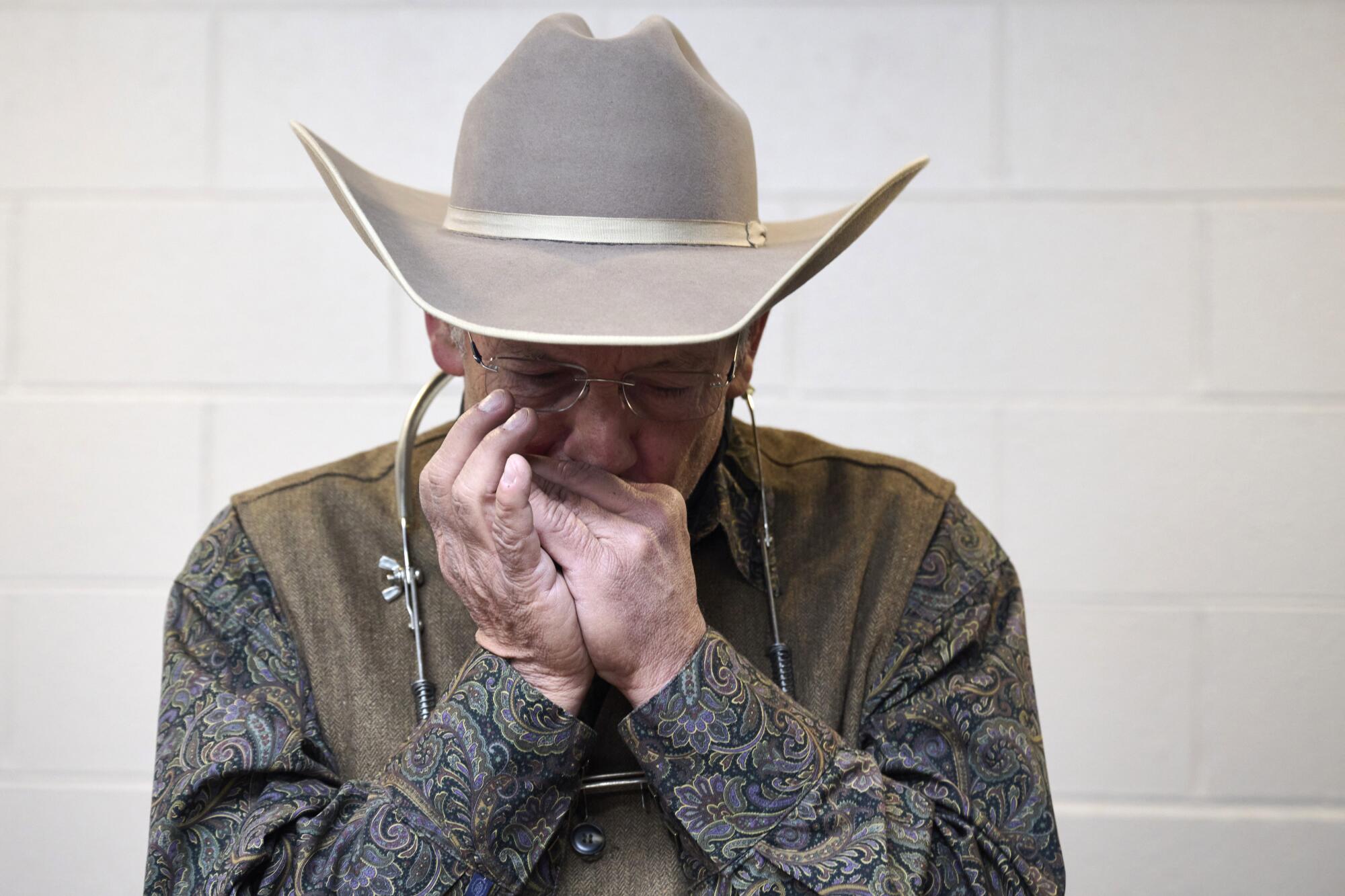 Musician Gene Veeder warms up backstage.