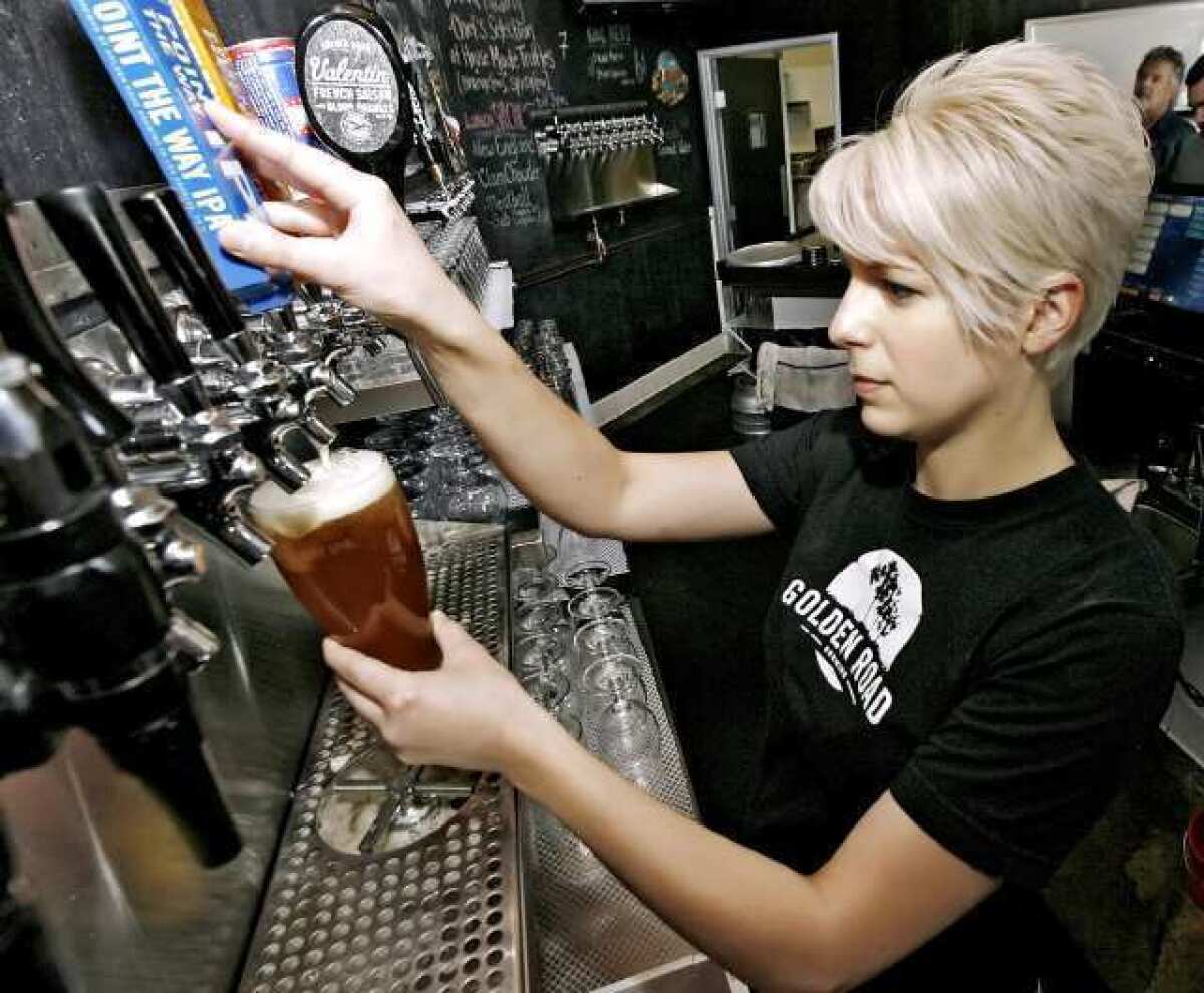 Bartender Sara Hildebrandt serves up a beer at Golden Road Brewing in Glendale.