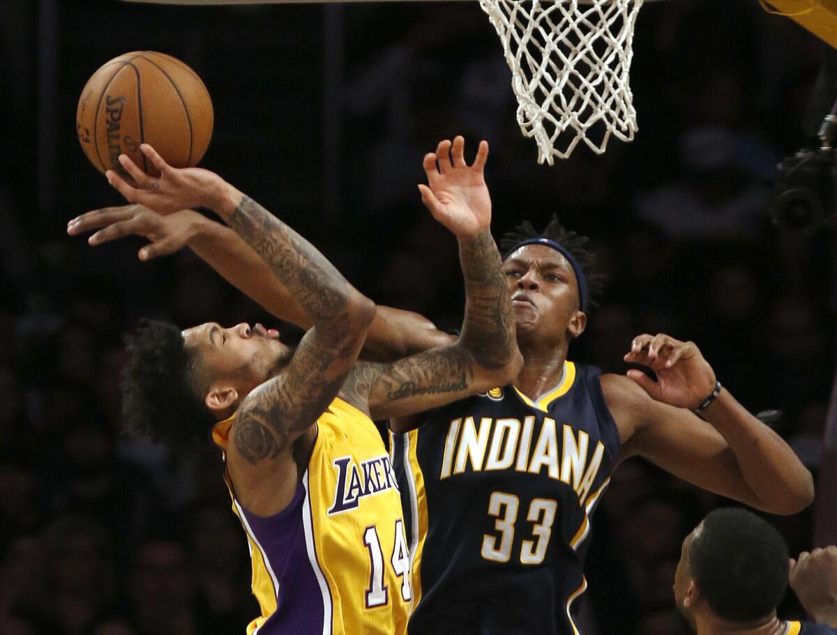 Lakers forward Brandon Ingram, left, tries to score against Pacers center Myles Turner during the first half.
