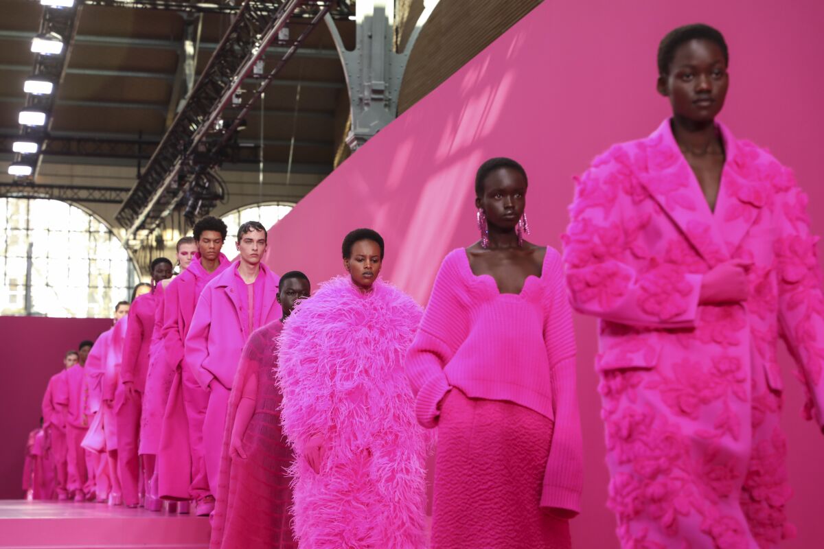 Models wear creations as part of the Valentino Ready To Wear Fall/Winter 2022-2023 fashion collection, unveiled during the Fashion Week in Paris, Sunday, March 6, 2022. (Photo by Vianney Le Caer/Invision/AP)