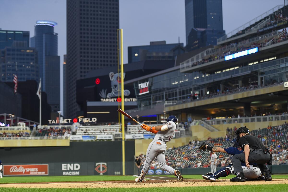 Houston's Jeremy Pena, left, hits a sacrifice fly to right field against the Minnesota Twins at Target Field on May 11.