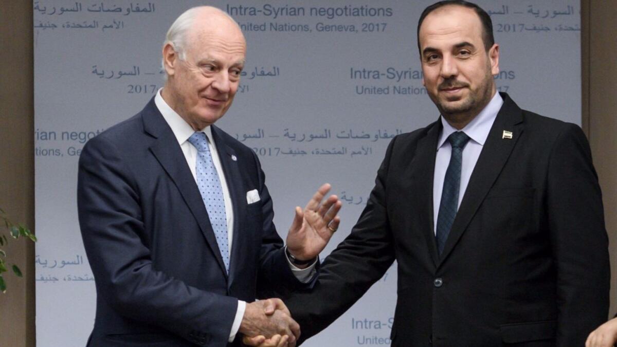 U.N. special envoy Staffan de Mistura (left) shakes hands with Syria's rebel delegation chief Nasr Hariri on Nov. 28, 2017, in Geneva.