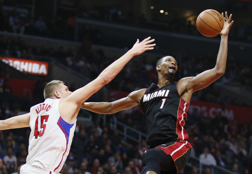 Miami Heat's Chris Bosh, right, brings in a defensive rebound next to Los Angeles Clippers' Cole Aldrich during the first half on Wednesday.