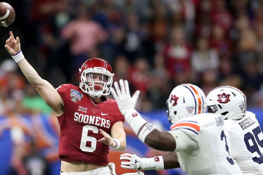 Oklahoma quarterback Baker Mayfield (6) throws a pass over Auburn defenders during the Allstate Sugar Bowl on Monday.