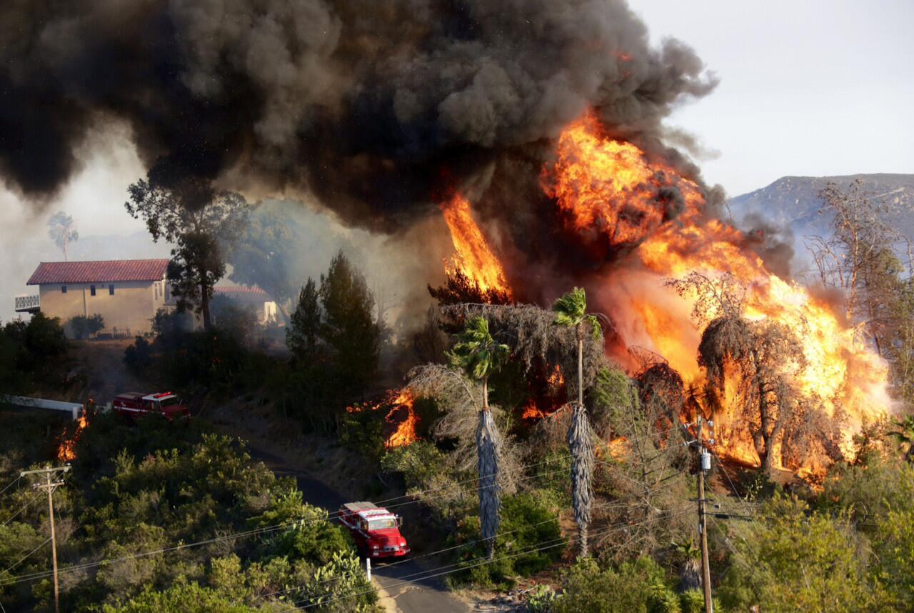 A huge fireball erupts as a structure burns on Coronado Hills Drive in San Marcos.