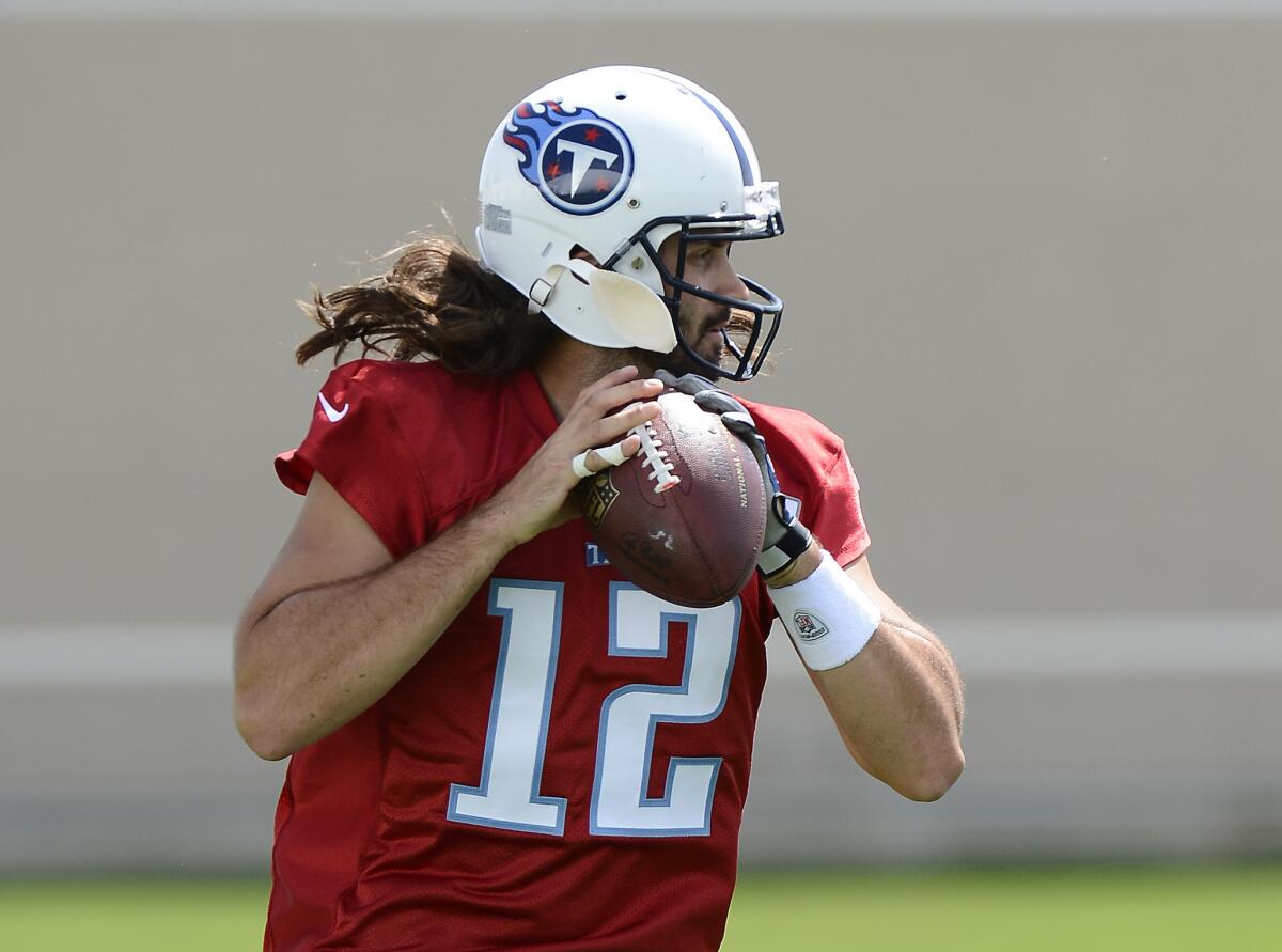 Tennessee Titans quarterback Charlie Whitehurst gives his new jersey number (12) a spin during a minicamp workout on April 29.