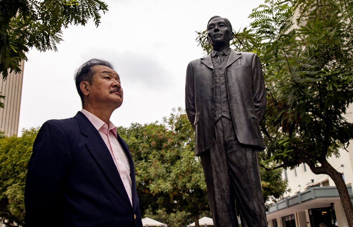UC Riverside professor Edward Taehan Chang stands near the statue of Dosan Ahn Chang Ho.