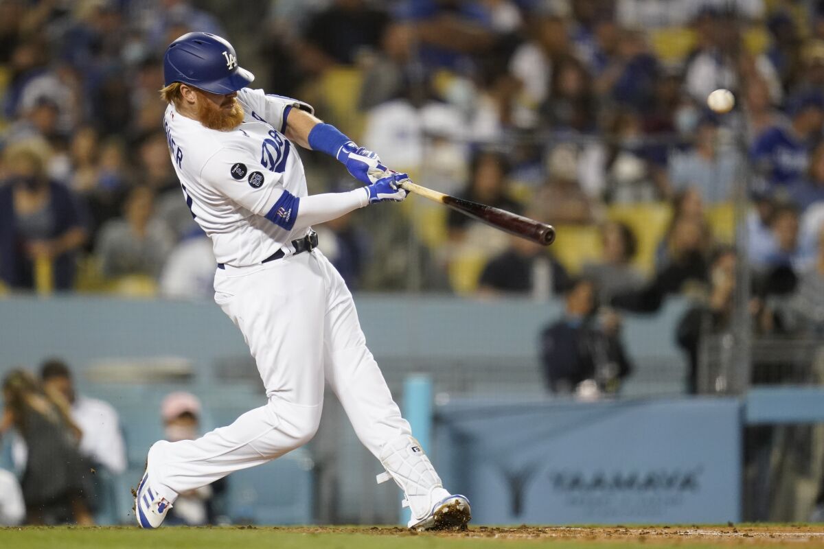 Los Angeles Dodgers' Justin Turner hits a home run during the fourth inning of a baseball game against the San Diego Padres Thursday, Sept. 30, 2021, in Los Angeles. (AP Photo/Ashley Landis)