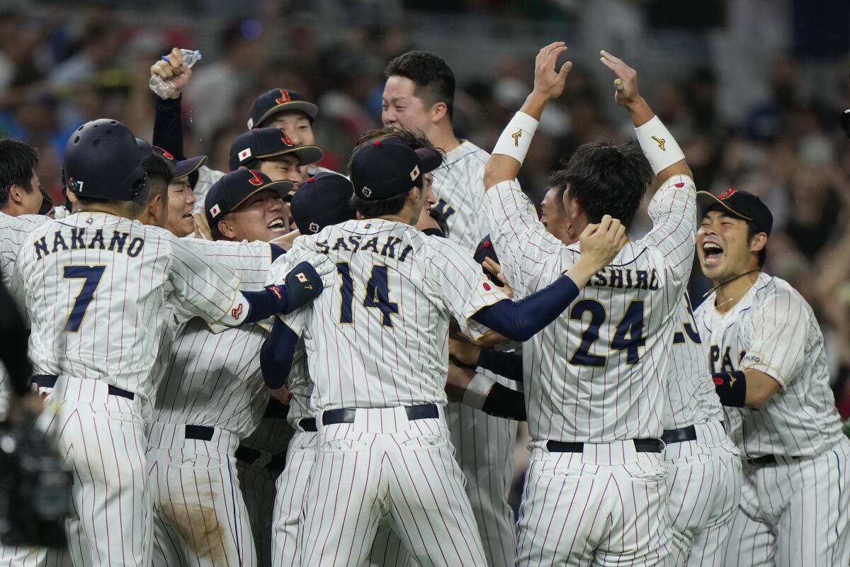 Japan players celebrate after beating Mexico 6-5 during a World Baseball Classic semifinal game.