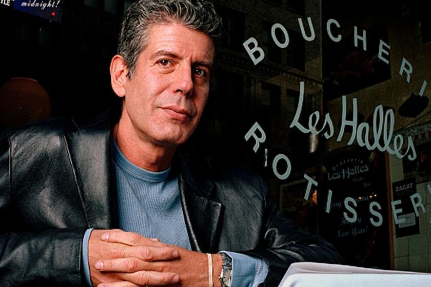 Anthony Bourdain the owner and chef of Les Halles restaurant sits at one of its tables in New York, Dec. 19, 2001. Bourdain is the executive chef at the two Les Halles restaurants in Manhattan and has become some what of a celebrity with his best?selling book "Kitchen Confidential" and the follow?up "A Cook's Tour" which has a companion TV series on the Food Network. (AP Photo/Jim Cooper)