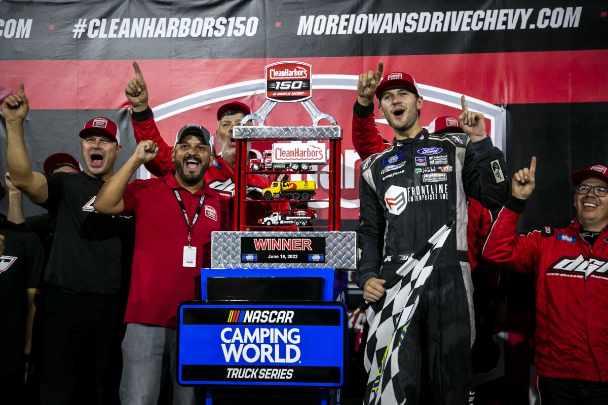 Todd Gilliland, center right, celebrates in Victory Lane after winning the NASCAR Truck Series auto race Saturday, June 18, 2022, at Knoxville Raceway in Knoxville, Iowa. (Joseph Cress/Iowa City Press-Citizen via AP)