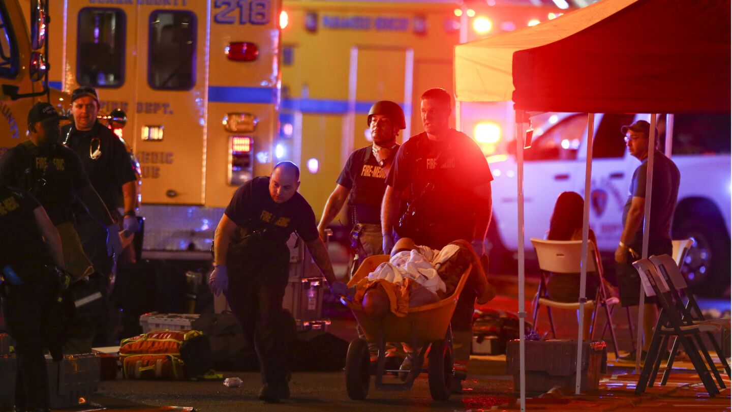 A wounded person is transported on a wheelbarrow as authorties respond during a mass shooting on the Las Vegas Strip on Sunday.