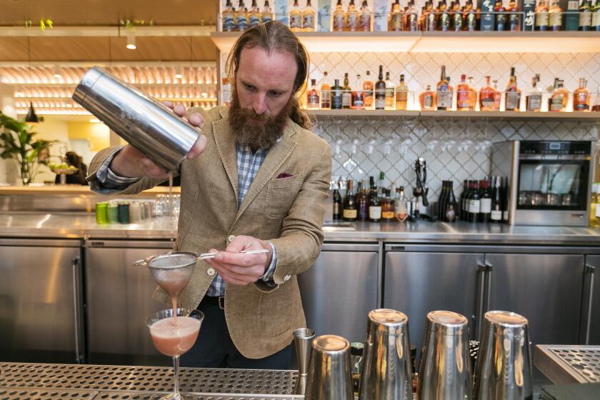 Mike Rooney, the beverage director at the Hall Global Eatery in South Coast Plaza, makes a drink on Monday, December 16.