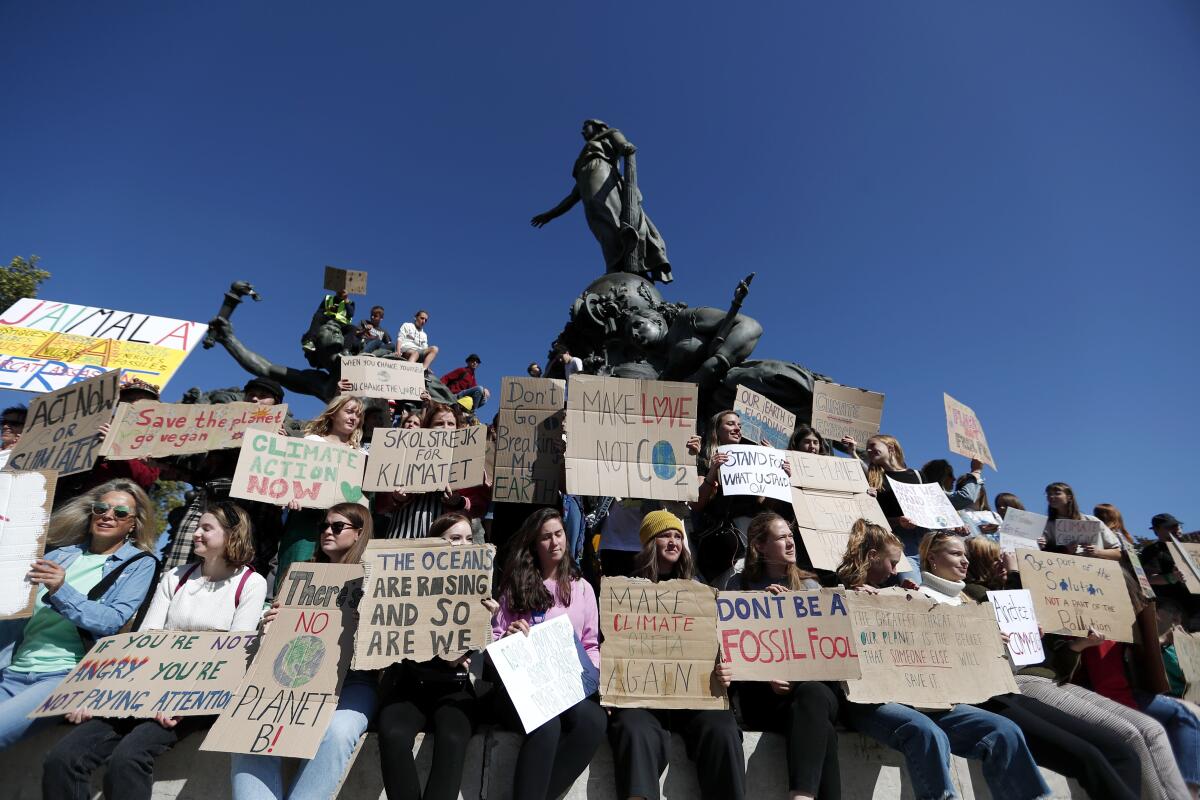 Protesters in Paris are part of a global day of demonstrations demanding action to address global warming.