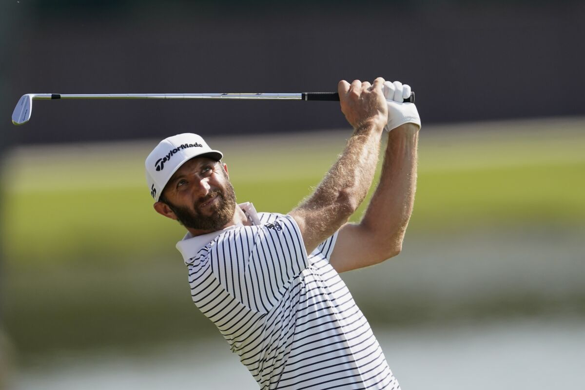 Dustin Johnson hits from the fairway on the 8th hole during the third round of the Tour Championship golf tournament at East Lake Golf Club in Atlanta, Sunday, Sept. 6, 2020. (AP Photo/John Bazemore)