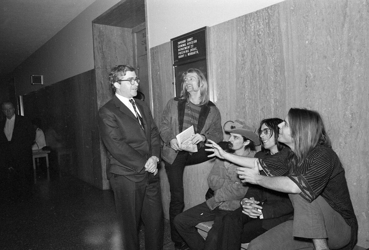 Attorney Brian Rohan, left, confers with Grateful Dead members in 1968 at their sentencing for possession of marijuana.   
