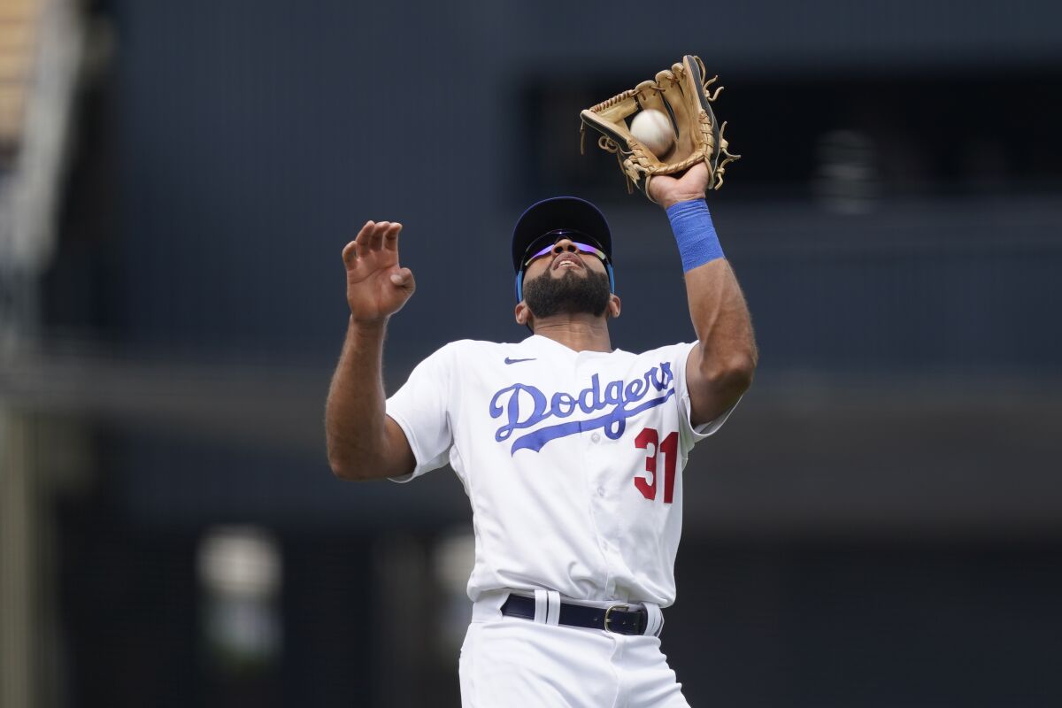 Dodgers shortstop Amed Rosario catches a pop fly during the eighth inning in Game 1 Saturday.