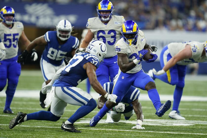 Los Angeles Rams' Sony Michel (25) runs against Indianapolis Colts' Khari Willis (37) during the second half of an NFL football game, Sunday, Sept. 19, 2021, in Indianapolis. (AP Photo/Michael Conroy)