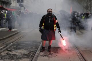 A demonstrator holds a flare during a protest Thursday, April 6, 2023 in Nantes, western France. Hundreds of thousands of people are expected to fill the streets of France Thursday for the 11th day of nationwide resistance to a government proposal to raise the retirement age from 62 to 64. The furious public reaction to the plan has cornered and weakened French President Emmanuel Macron. (AP Photo/Jeremias Gonzalez)