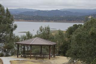 A picnic area is seen along Lake Berryessa with parts of California's newest national monument in the background Friday, July 10, 2015, near Berryessa Snow Mountain National Monument, Calif. California's newest national monument covers hundreds of thousands of acres from marshes to the mountain peaks 6,000 feet above them, and countless critters in between - badgers, eagles, bears, bats, butterflies, and mountain lions, among others. Federal protection will let an entire coastal range better weather the warming of climate change, supporters say. (AP Photo/Eric Risberg)