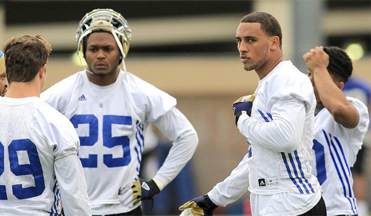 Dietrich Riley, right, is back at practice for UCLA after undergoing neck surgery to repair an injury he suffered during a collision with Cal running back Isi Sofele in 2011.