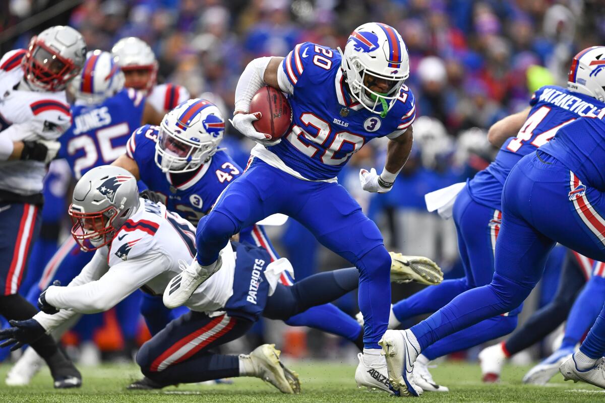 Buffalo Bills running back Nyheim Hines (20) runs in a touchdown on a kickoff return during the first half of an NFL football game against the New England Patriots, Sunday, Jan. 8, 2023, in Orchard Park. (AP Photo/Adrian Kraus)
