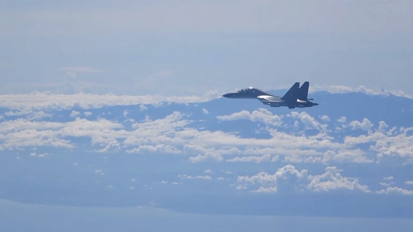 In this image made from video and released by China's Xinhua News Agency, a Chinese military plane flies during a training exercise of the air force corps of the Eastern Theater Command of the Chinese People's Liberation Army (PLA), Friday, Aug. 5, 2022. China conducted "precision missile strikes" Thursday in waters off Taiwan's coasts as part of military exercises that have raised tensions in the region to their highest level in decades following a visit by U.S. House Speaker Nancy Pelosi. (Xinhua via AP)