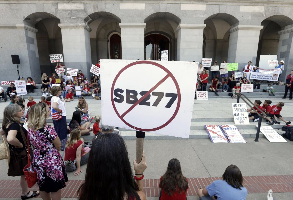 Opponents of a measure requiring nearly all California school children to be vaccinated gather on the west steps of the state Capitol after lawmakers approved the bill.
