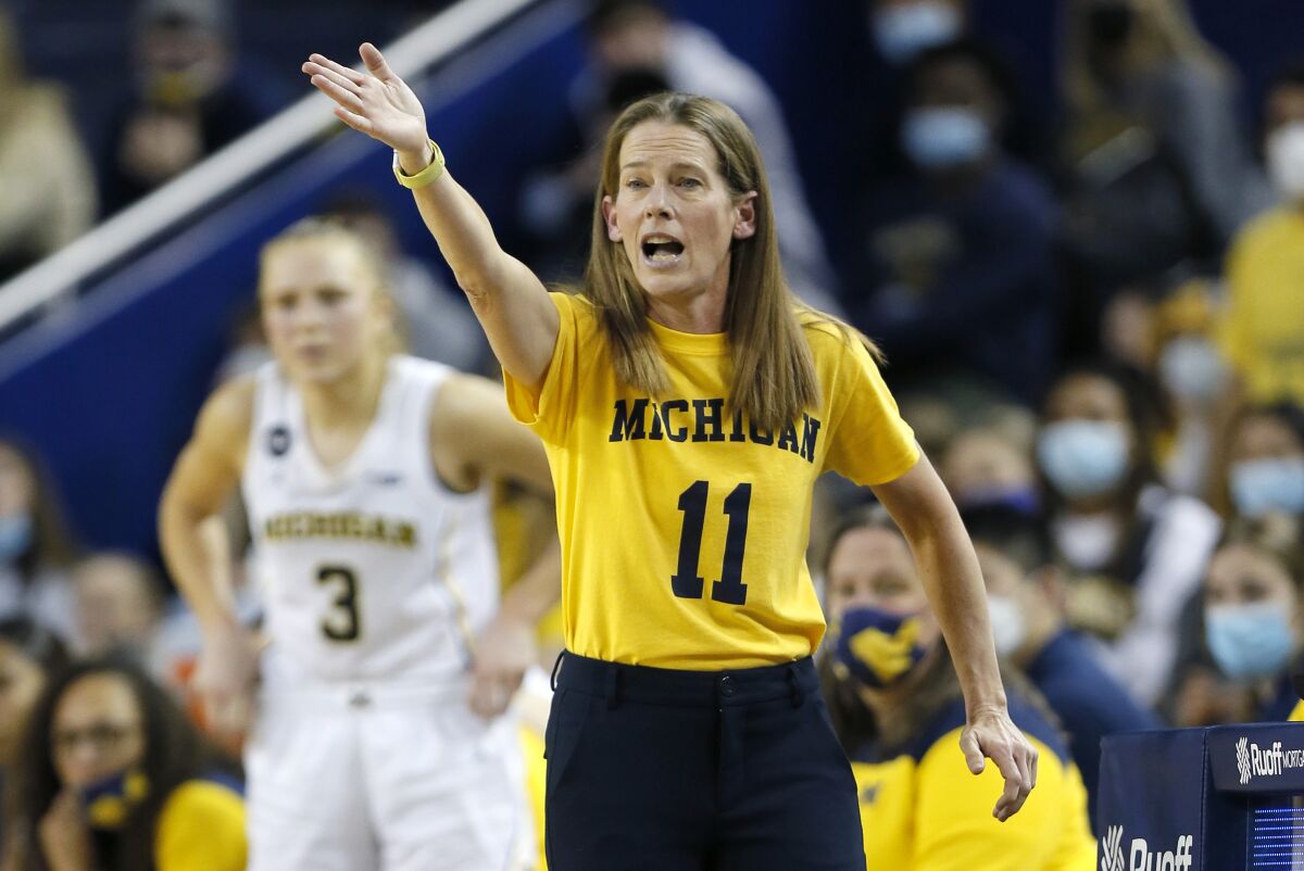 Michigan coach Kim Barnes Arico shouts instructions to the team during the second half of an NCAA college basketball game against Michigan State on Thursday, Feb. 24, 2022, in Ann Arbor, Mich. (AP Photo/Duane Burleson)