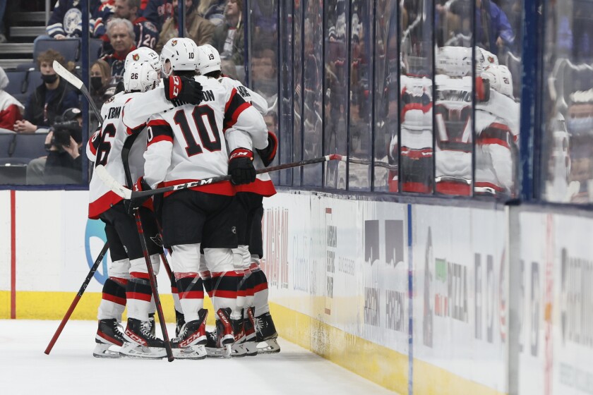 Ottawa Senators players celebrate their goal against the Columbus Blue Jackets during the second period of an NHL hockey game, Sunday, Jan. 23, 2022, in Columbus, Ohio. (AP Photo/Jay LaPrete)