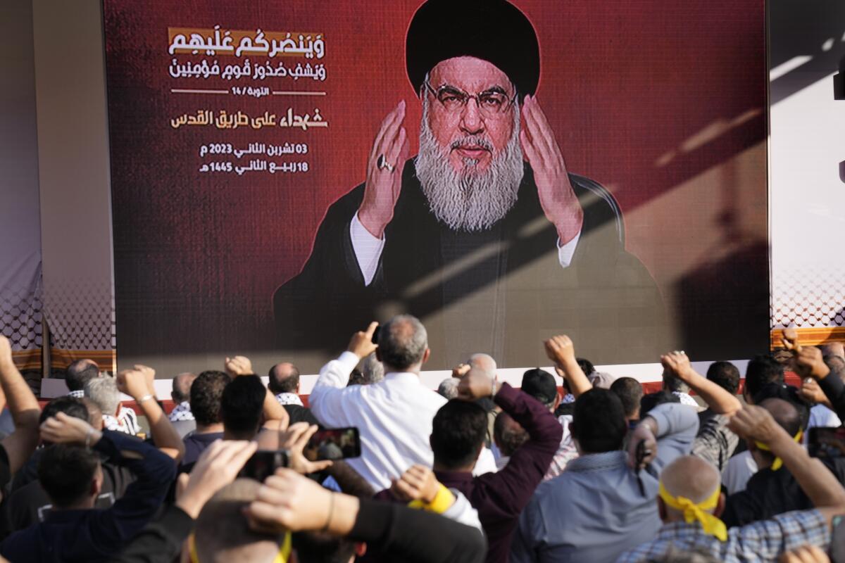 Hezbollah leader Hassan Nasrallah greets his supporters via a video link in Beirut.