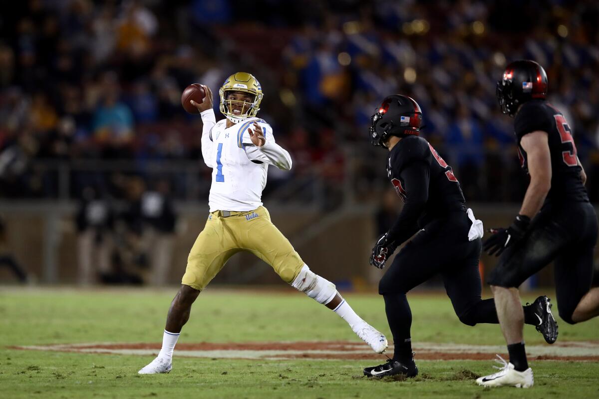 PALO ALTO, CALIFORNIA - OCTOBER 17: Dorian Thompson-Robinson #1 of the UCLA Bruins throws the ball while being pressured by Gabe Reid #90 and Casey Toohill #52 of the Stanford Cardinal at Stanford Stadium on October 17, 2019 in Palo Alto, California. (Photo by Ezra Shaw/Getty Images)