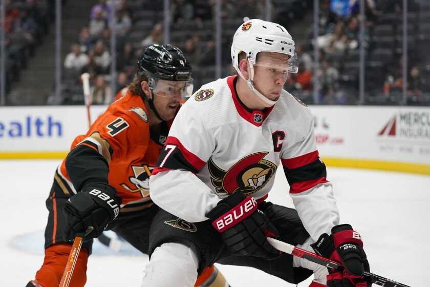 Ottawa Senators' Brady Tkachuk, right, is defended by Anaheim Ducks' Cam Fowler during the first period of an NHL hockey game Friday, Nov. 26, 2021, in Anaheim , Calif. (AP Photo/Jae C. Hong)