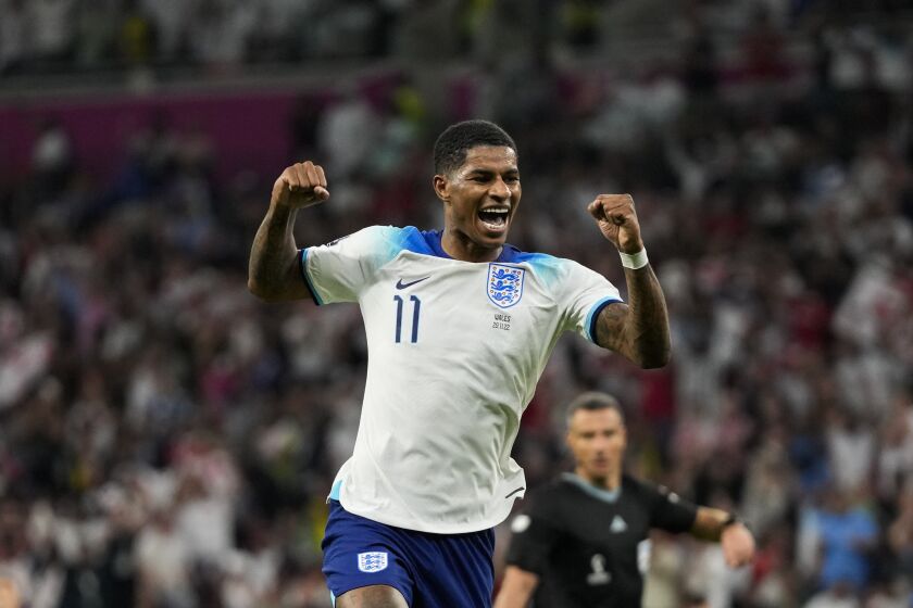 England's Marcus Rashford celebrates after scoring his side's third goal during the World Cup group B soccer match between England and Wales, at the Ahmad Bin Ali Stadium in Al Rayyan , Qatar, Tuesday, Nov. 29, 2022. (AP Photo/Frank Augstein)