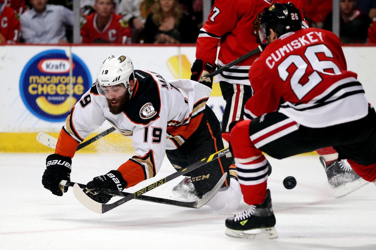Ducks left wing Patrick Maroon tries to make a pass around Blackhawks defenseman Kyle Cumiskey while falling to the ice in the first period of Game 6 on Wednesday night in Chicago.