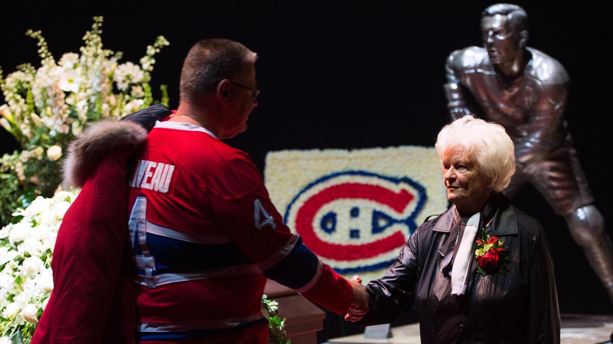The widow of former Montreal Canadiens great Jean Beliveau, Elise, greets fans during the public viewing at Bell Centre in Montreal, Canada, on Sunday.