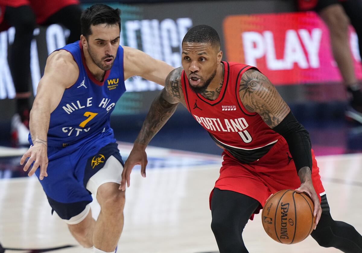 The Trail Blazers' Damian Lillard drives past the Nuggets' Facundo Campazzo in Game 1 on May 22, 2021.