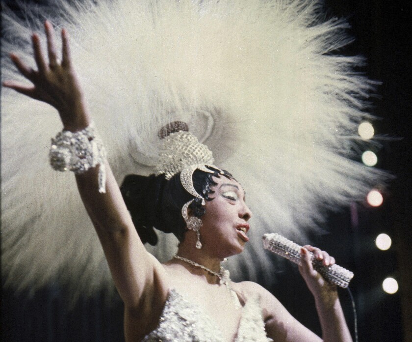 Josephine Baker on stage in an elaborate white outfit